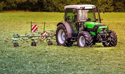 Traktor finansiert av næringskreditt, driftskreditt i Luster Sparebank køyrer på ei mark. Foto
